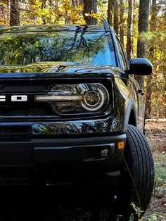 Front headlight of a new Ford Bronco Sport Outer Banks in Shadow Black parked in a forest area 2023 Bronco, Ford Bronco Sport Outer Banks, Bronco Sport Outer Banks, Livonia Michigan, Ford Interior, Exterior Finishes, Ford Bronco Sport, Bronco Sport, Dream Vehicles