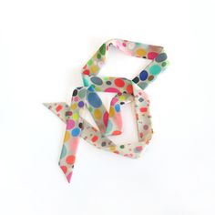 "Polka-dot and geo shapes pattern-play skinny scarf in bright and pastel colors on a pale beige. Ready to ship, special edition midi-length skinny scarf designed by Cinne. Full of character with endless styling possibilities. Wear around your neck, in your hair, tied on your favorite bag, or around your wrist. Find more styling examples in second to last photo. Constructed entirely by hand with love and attention to every detail. . . . . . . . . . . . . . . . . . . . . . . . . . . . . . . . . . Silk Scarf With Ribbon For Gift, Retro Multicolor Scarves For Gifts, Retro Multicolor Scarves For Gift, Retro Multicolor Silk Scarf Gift, Ribbon Scarf, Shapes Pattern, Pale Beige, Scarf Hair, Scarf Neck