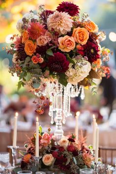 an elegant centerpiece with candles and flowers