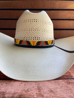 Hand beaded hatband made with leather ends. Orange, yellow, and blue western pattern. Multicolor Beaded Hats For Rodeo, Western Beaded Rodeo Hat, Traditional Beaded Hat Bands For Rodeo, Traditional Beaded Hat Bands For Country Events, Western Multicolor Hat Bands For Rodeo, Adjustable Yellow Hats For Country Events, Adjustable Yellow Hat For Country Events, Multicolor Western Hat For Rodeo, Western Multicolor Hat For Rodeo