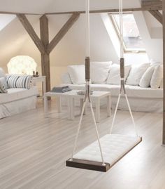 a living room with white furniture and wood beams on the ceiling is pictured in this image