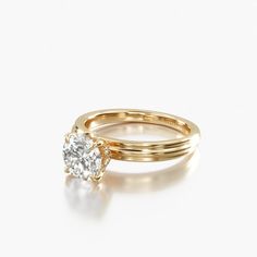 a yellow gold engagement ring set with a round brilliant diamond in the center, on a white background