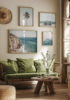 a living room filled with green furniture and pictures on the wall above it's coffee table