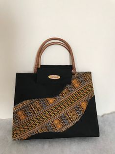 African Kente Handbag/Purse. Elegant and stylish. African Fabric/Multi Colored Bag with bamboo/cane handles.  Handles may vary and subject to availability. Handles may come in bamboo, clear or any other color. Pattern on fabric may also vary  Size is approximately 16.5 (L) x 11 inches (H) X 3.5 (W) Ankara Bags, Multi Colored Bag, African Bag, African Accessories, Vanity Bag, Handmade African, Top Handle Bags, Black Purse, Handbag Black