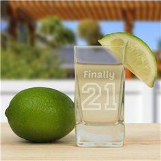 a lime next to a shot glass with the number 21 on it