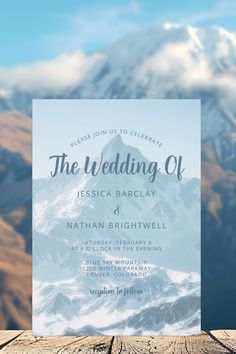 a mountain scene with the words, the wedding of written in blue ink on a card