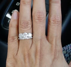 a close up of a person's hand with a wedding ring on their finger