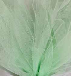 a close up view of the back of a green tulle