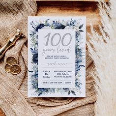 a white and blue floral wedding card with the words 100 years loved written on it