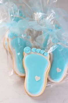 baby feet decorated cookies in plastic bags on a table