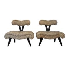 pair of mid century modern lounge chairs with upholstered cushions