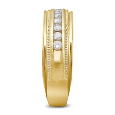 a yellow gold wedding ring with three diamonds