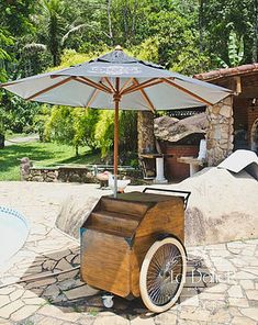 an old fashioned ice cream cart sitting on top of a stone patio