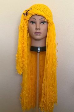 a wig with long yellow hair on top of a mannequin's head