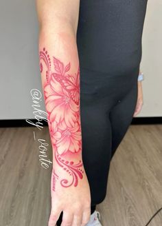 a woman's arm with pink flowers on it