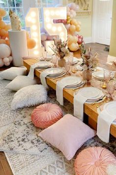 the table is set with pink and white decorations