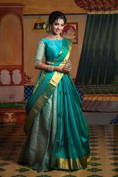 a woman in a green and gold sari