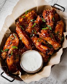 chicken wings with ranch dressing in a basket