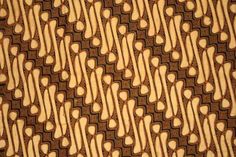 a close up view of a tie with brown and white designs on it