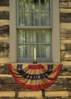 an american flag draped in front of a window