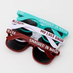 three pairs of sunglasses with names on them sitting next to each other in front of a white background