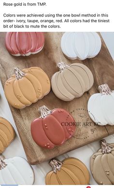 some fake pumpkins are sitting on a cutting board