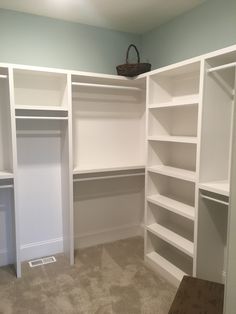 an empty walk - in closet with white shelving and shelves on the wall, carpeted floor