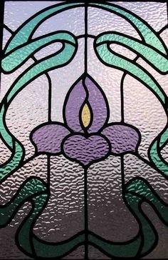 a stained glass window with a flower on it