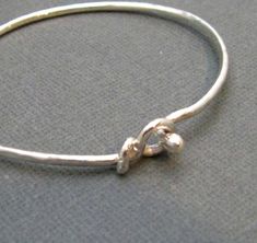 This simple bracelet is a great bangle to wear alone or  it can be a perfect layering piece.  It´s forged from sturdy 12 gauge wire and is work hardened to keep its shape.  Small hook fits easily into the keyhole closure and will stay securely on your wrist.  Polished to a high shine and made to order.  Allow 10 business days for fabrication.XSmall - fits 5-5.5 inch wristSmall - fits 5.5-6 inch wristMedium - fits 6-6.5 inch wristLarge - fits 6.5-7 inch wristXLarge - fits 7 - 7.5 inch wristAny qu Cuff Bangle Bracelet, Simple Bracelets, 12 Gauge, Beaded Drop Earrings, Boho Bracelet, Minimalist Bracelet, Bracelet Sterling Silver, Jewelry Boho, Silver Pieces