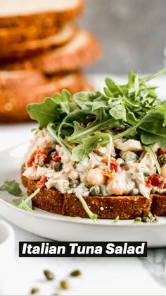 a close up of a plate of food with bread and garnish on it