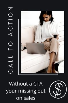 a woman sitting on top of a white couch holding a laptop next to a cup