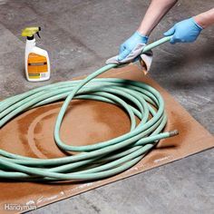 a person is using a hose to clean the floor