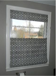 a bathroom window with a black and white pattern on it