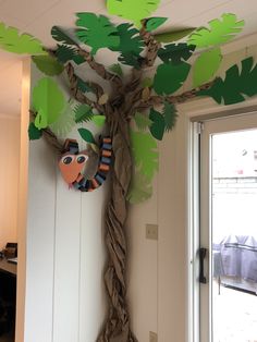 a paper tree hanging from the ceiling next to a door