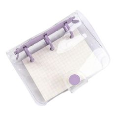 a note pad with purple handles and clippings attached to the back of it