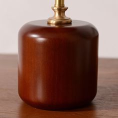 a wooden table with a metal top and a light on the top that is turned off