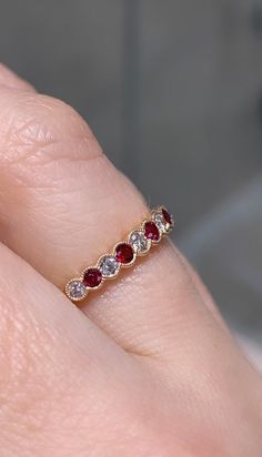 Mix and match! Beautiful diamond & ruby ring. Bezel set round diamonds and genuine natural emerald with milgrain details. Metal: 18K Rose GoldDiamond Weight: 6 Rounds 0.19ctsEmerald Weight: 5 Round-cut Ruby 0.21ctwRing Width: 2.8mm Ruby Bands, Ring Bezel, Ruby Ring, Rose Gold Diamonds, Natural Emerald, Bezel Setting, 18k Rose Gold, Mix And Match, Round Cut