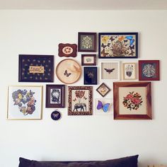 there are many framed pictures on the wall