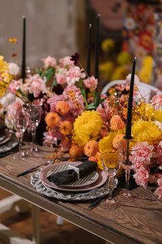 the table is set with flowers and candles