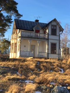 a large white house sitting on top of a hill