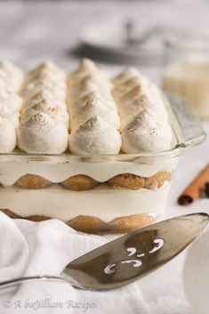 a dessert dish with meringue and cinnamon sticks