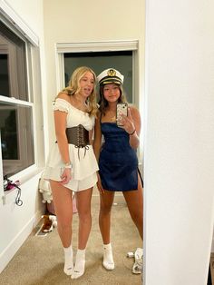 two women dressed in costumes taking a selfie