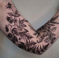 a person's arm with flowers and birds on it