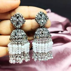 Embrace the elegance of tradition with our handcrafted Oxidized Silver Jhumka Earrings, perfect for any bridal ensemble or festive occasion. These exquisite earrings feature intricate filigree work on oxidized silver, reflecting the rich craftsmanship of Indian jewelry design. The delicate white bead fringes add a playful yet sophisticated charm, making them a stunning choice for weddings, celebrations, or everyday elegance. Materials: Oxidized Silver White Beads Features: Handcrafted with atten Silver Jhumka Earrings, Best Jewellery Design, Oxidised Earrings, Pretty Jewelry Necklaces, Indian Bridal Jewelry, Wedding Accessory, Indian Jewellery Design, Engagement Party Wedding, Bridal Jewellery Indian