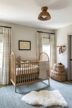 a baby's room with a crib, rug and deer head on the wall