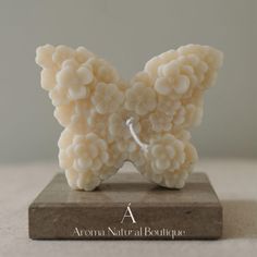 a sculpture made out of white beads on a wooden block