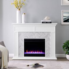 a white fireplace with an electric fire place