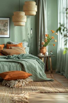 a bedroom with green walls and orange pillows