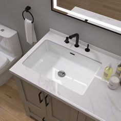 a bathroom with a sink, toilet and mirror