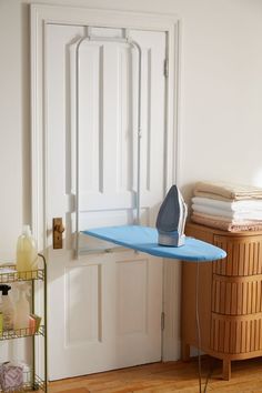 an ironing board is sitting on top of a cabinet